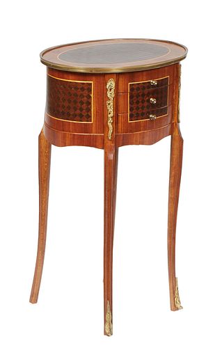 French Inlaid Cherry Ormolu Mounted Oval Lamp Table, 20th c., the brass bound oval parquetry top over a back of three small drawers on one side, on ta