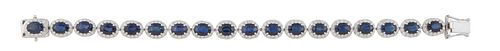 14K White Gold Link Bracelet, each of the eighteen oval links with a graduated oval sapphire, atop a border of tiny round diamonds, total sapphire wt.