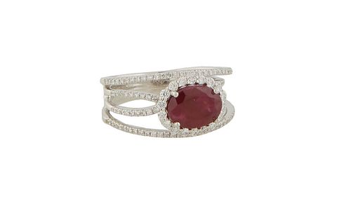 Lady's Platinum Ruby Dinner Ring, with an oval 2.97 ct. horizontal ruby, atop a border of tiny round diamonds, centering a split shoulder band of tiny