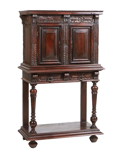 French Provincial Henri II Style Carved Walnut Side Cabinet, c. 1880, the stepped crown over double fielded panel doors flanked by feather carved pila