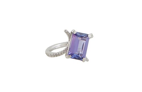 Lady's 18K White Gold Dinner Ring, with an emerald cut 3.67 ct. tanzanite, atop a diamond mounted swirled bypass band, total diamond wt.- .53 cts., Si