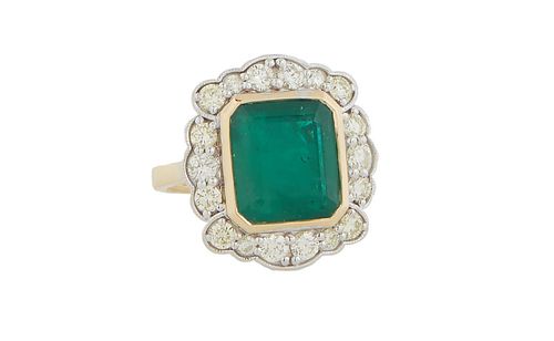 Lady's 18K Yellow Gold Dinner Ring, with an octagonal cut 6.76 ct. emerald, within a carved border of round diamonds, total diamond wt.-1.24 cts., siz