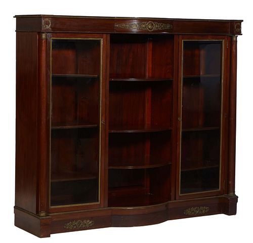 French Empire Style Ormolu Mounted Mahogany Bookcase, early 20th c., the bowed breakfront top over two glazed doors flanking open bowed shelves, flank