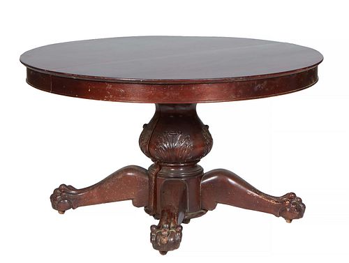 English Carved Mahogany Oval Banquet Table, 19th c., the top over a wide skirt, on a large relief carved urn support to four large splayed ball and cl