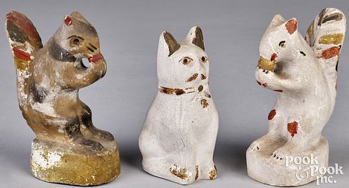 Two Pennsylvania chalkware squirrels and a cat