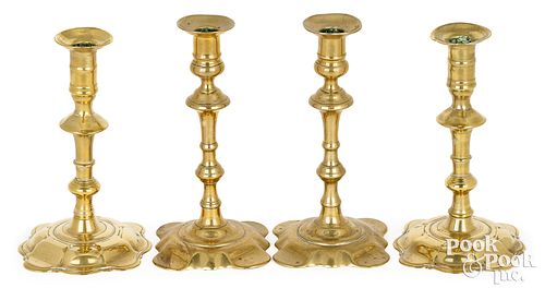 Two pair of Queen Anne brass candlesticks