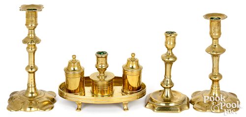 Three Queen Anne brass candlesticks and a standish