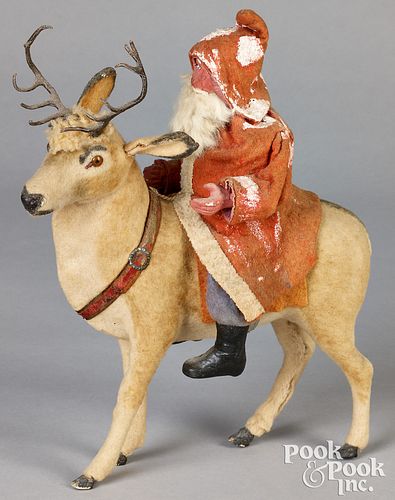 Santa Claus riding a reindeer candy container