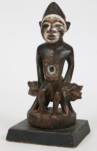 AFRICAN CARVED WOOD, PIGMENT AND GLASS SEATED FIGURE H 10" W 5.5" 