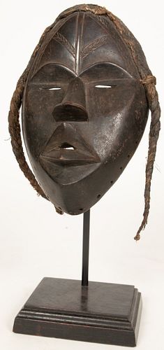 DAN PEOPLE, LIBERIA AND COTE D'IVOIRE, AFRICAN CARVED WOOD MASK WITH BRAIDS 20TH CENTURY H 14" W 5" D 4" 