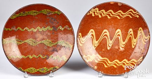 Two slip decorated redware chargers, 19th c.
