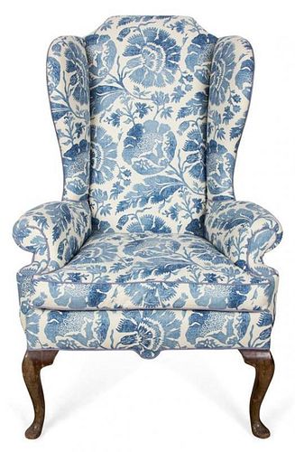 An English Upholstered Wing Back Armchair Height 50 inches.