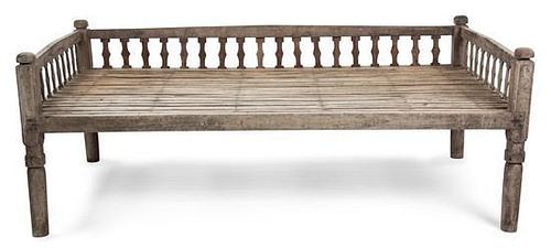 An Indian Carved Wood Bed Height 30 1/2 x width 80 1/2 x depth 43 1/4 inches.