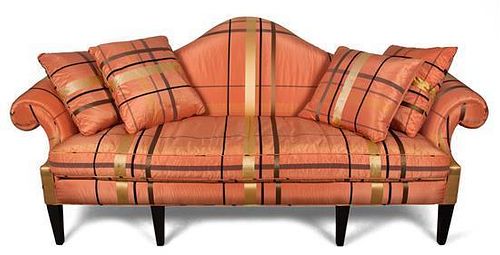 A George III Style Peach-Upholstered and Ebonized Camel-Back Sofa Height 34 1/2 x width 95 x depth 34 inches.