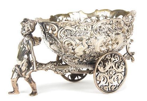 A Continental Silver Reticulated Basket on Wheels, 19th century, the oval basket raised on two wheels, being pulled by a putt