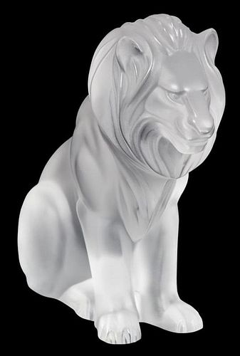 A Lalique Molded and Frosted Glass Figure of a Seated Lion Height 8 1/4 inches.