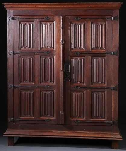 A FINE CARVED OAK “LINENFOLD” AND WROUGHT IRON