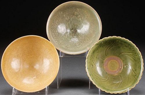 A GROUP OF THREE VIETNAMESE CARVED CELADON BOWLS