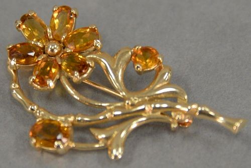 14K gold brooch with amber color stones in form of flower.
