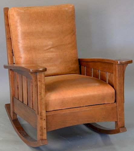 Stickley cherry mission style rocking chair with leather cushions.