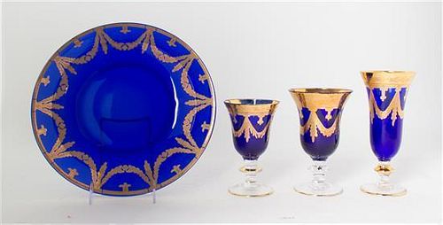 A Gilt Decorated Cobalt Glass Stemware Service, Diameter of charger 12 inches.