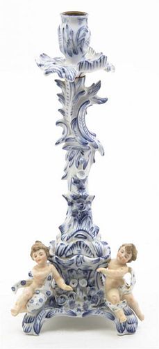 A German Porcelain Figural Candlestick, Height 10 3/8 inches.