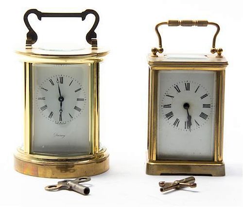 * Two Brass Carriage Clocks, Height of first over handle 6 1/4 inches.