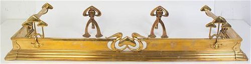 * An Art Nouveau Brass Fireplace Set, Length of fender 52 1/2 inches.
