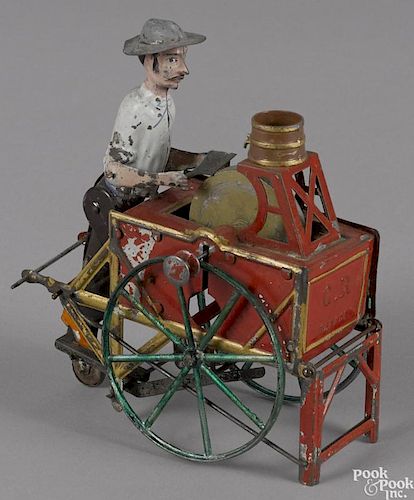 Charles Rossignol hand painted tin knife grinder cart toy with a flywheel, 5 1/2'' l.