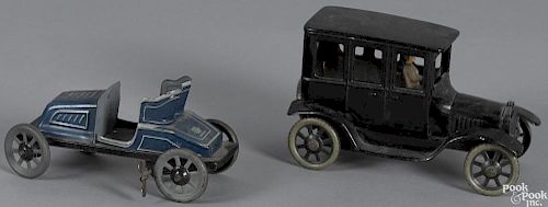 Two Bing tin lithograph clockwork autos, to include a Ford sedan, 6 1/2'' l., and an open roadster