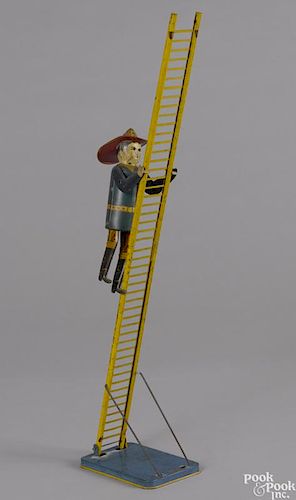 Marx tin lithograph wind-up climbing fireman, 22'' overall height.