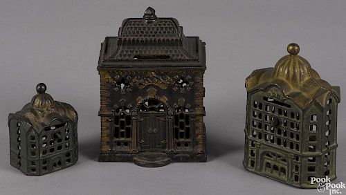 Three cast iron still bank buildings, to include a J. & E. Stevens roof bank, 5 1/2'' h.