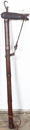 A Bamboo Iron and Carved Wood Implement, Height 55 1/2 inches.