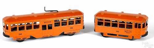 Two Kingsbury pressed steel clockwork trolley cars, to include no. 782 and 784, 9'' l.