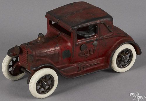 Arcade cast iron Fire Chief coupe car with a nickel-plated driver and rubber wheels, 6 3/4'' l.