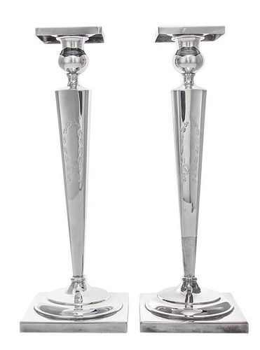 * A Pair of American Silver Candlesticks, , on square bases and with tapered fluted stems, weighted