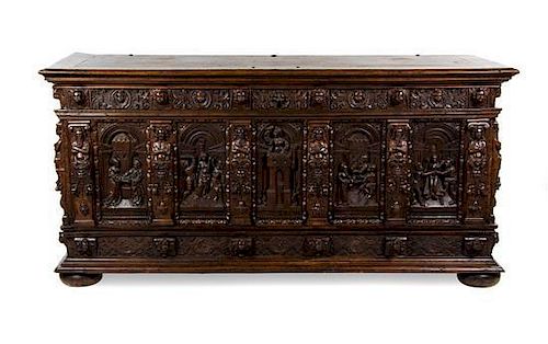 A Renaissance Style Carved Oak Casonne, Height 40 x width 82 x depth 30 inches.