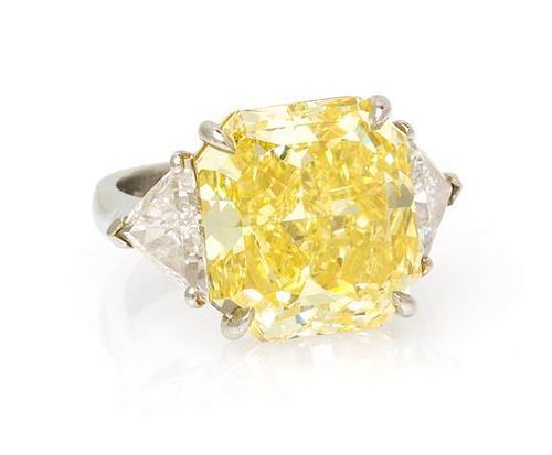 A Fine Platinum, Fancy Intense Yellow Diamond and Diamond Ring, 7.40 dwts.