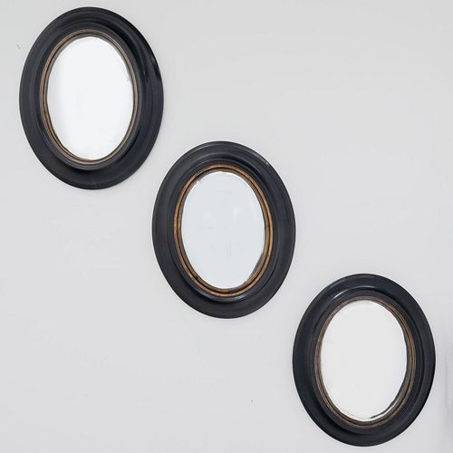 Group of Three Large Oval Ebonized and Brass Convex Mirrors 