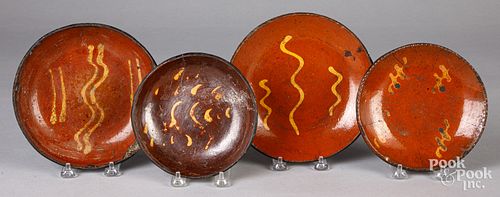 Four Pennsylvania redware plates, 19th c.