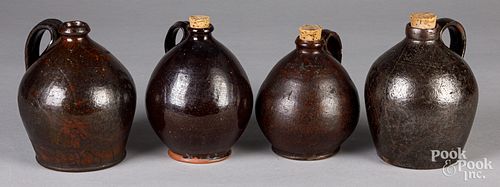 Four redware jugs, 19th c.