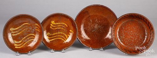 Three redware plates and a mixing bowl, 19th c.