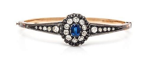 A Silver Topped Gold, Sapphire and Diamond Bangle Bracelet, 8.60 dwts.