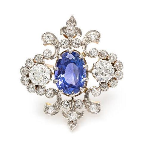 An Edwardian Platinum Topped Gold, Sapphire and Diamond Fleur-de-lys Brooch, 5.90 dwts.