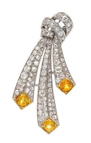 An Art Deco Platinum, Yellow Sapphire and Diamond Brooch, 10.50 dwts.