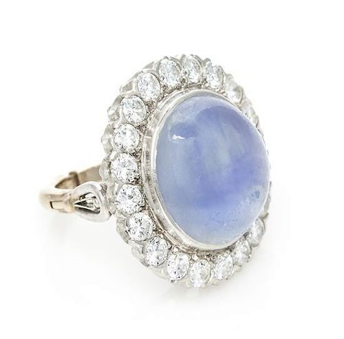 A Platinum, Yellow Gold, Star Sapphire and Diamond Ring, 12.20 dwts.