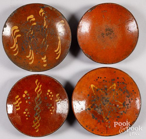 Four redware plates, early 19th c.