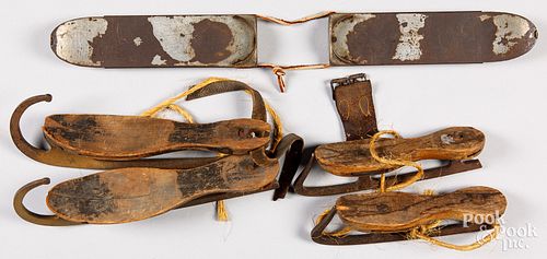 Two pairs of iron and wood ice skates