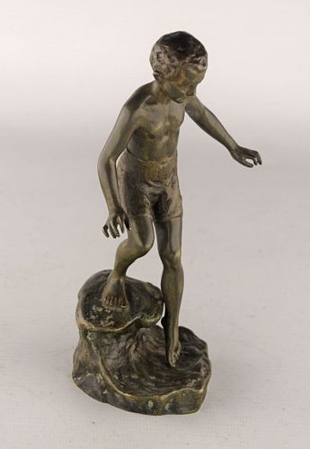 Bronze sculpture of a boy climbing into the water