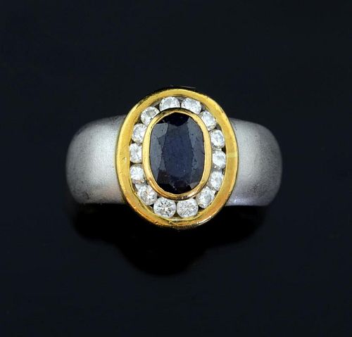Sapphire and diamond cluster ring, oval cut sapphire to the centre with a surround of round brilliant cut diamonds in yellow 